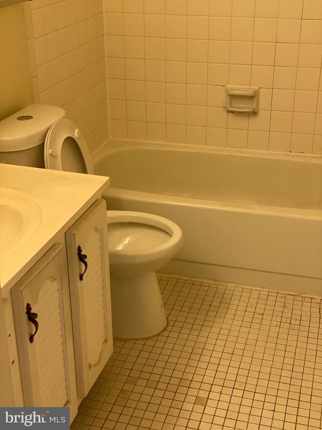 full bath with bathtub / shower combination, vanity, toilet, and tile patterned floors