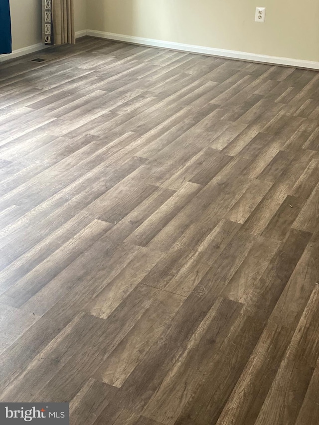 room details with visible vents, baseboards, and wood finished floors