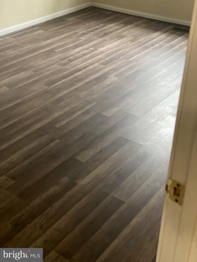 interior details featuring baseboards and wood finished floors