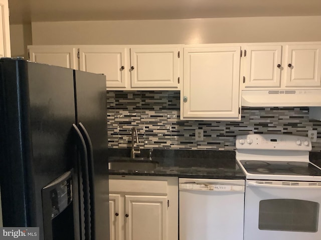 kitchen with dark countertops, white cabinets, a sink, white appliances, and under cabinet range hood