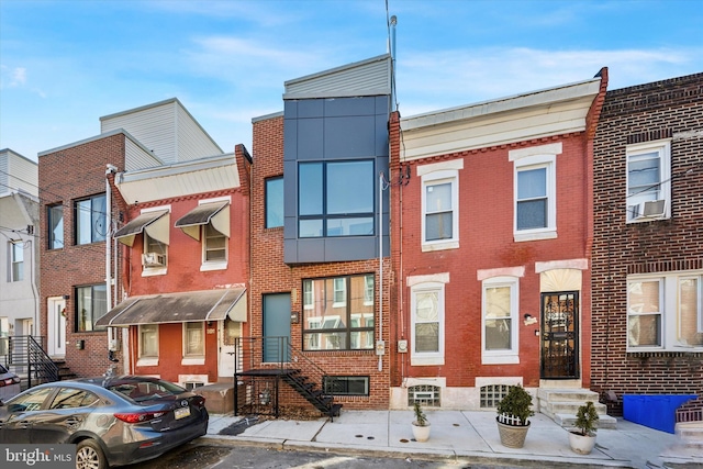 townhome / multi-family property featuring brick siding