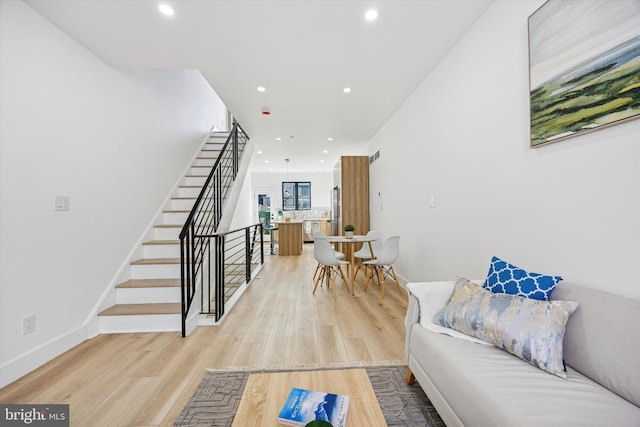 interior space with stairway, light wood-style flooring, recessed lighting, and baseboards