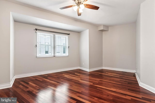 spare room featuring ceiling fan, wood finished floors, and baseboards