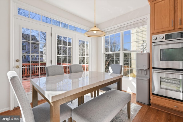 dining area featuring baseboards and wood finished floors