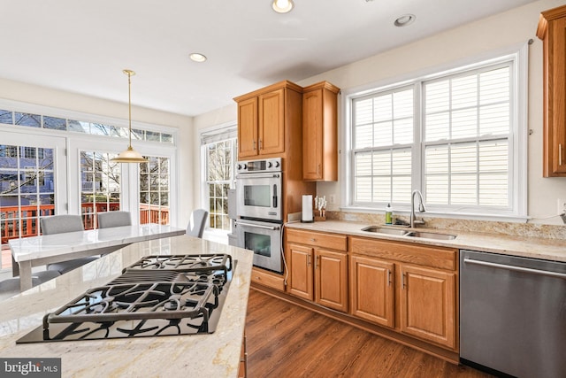 kitchen featuring dark wood-type flooring, stainless steel appliances, a sink, and recessed lighting