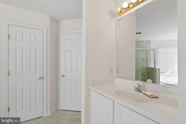 bathroom featuring a shower stall and vanity