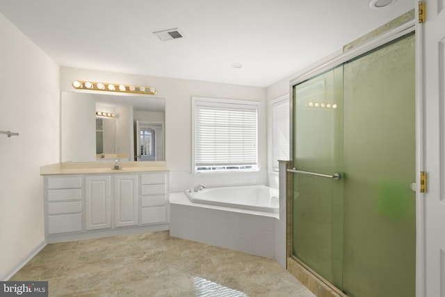 bathroom featuring a stall shower, visible vents, a garden tub, and vanity