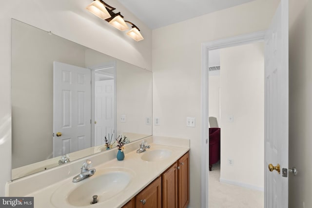 bathroom featuring visible vents, a sink, and double vanity