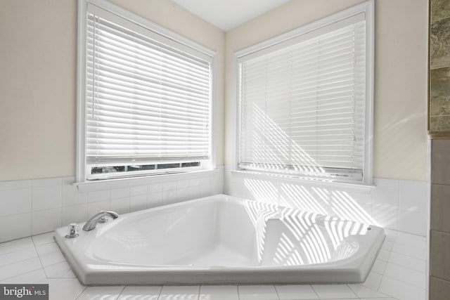 bathroom featuring a garden tub and tile walls