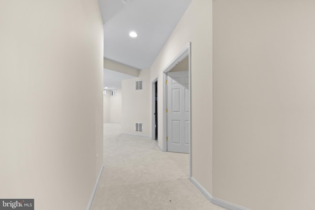 hallway with light carpet, recessed lighting, visible vents, and baseboards