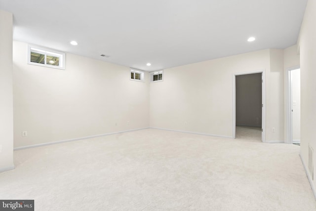 basement featuring recessed lighting, light carpet, and visible vents