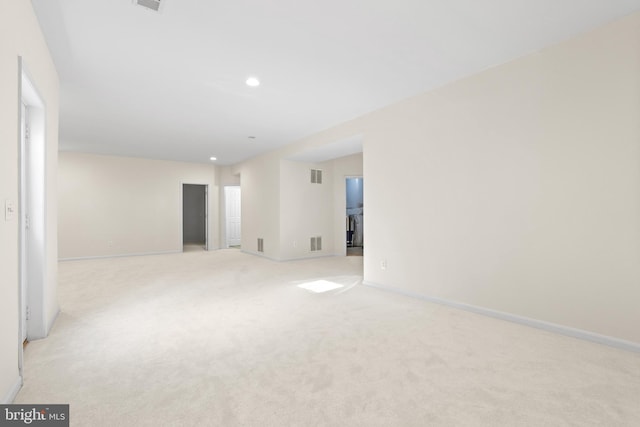 empty room with light carpet, baseboards, and visible vents