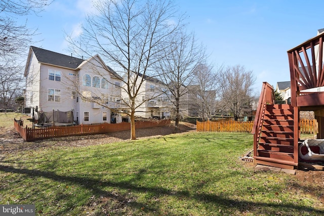 view of yard with stairway, fence, and a deck