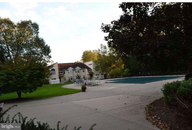 outdoor pool with a patio area