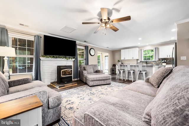 15185 Day Rd, Goldsboro, MD 21636 - living area featuring ornamental molding, a ceiling fan, wood finished floors, recessed lighting, and a wood stove