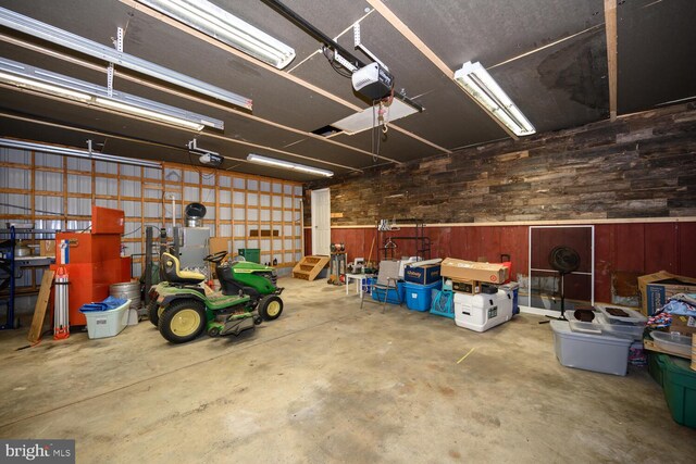 15185 Day Rd, Goldsboro, MD 21636 - garage featuring wooden walls and a garage door opener