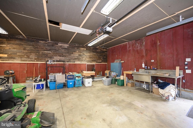 15185 Day Rd, Goldsboro, MD 21636 - garage featuring wooden walls, a workshop area, and a garage door opener