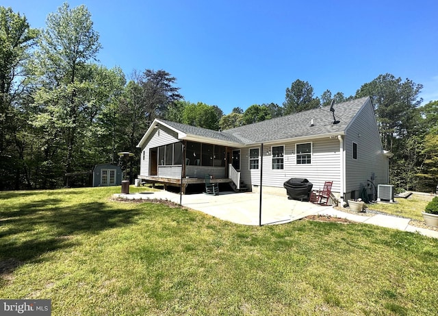 15185 Day Rd, Goldsboro, MD 21636 - rear view of house with a patio area, a sunroom, central AC, a lawn, and roof with shingles