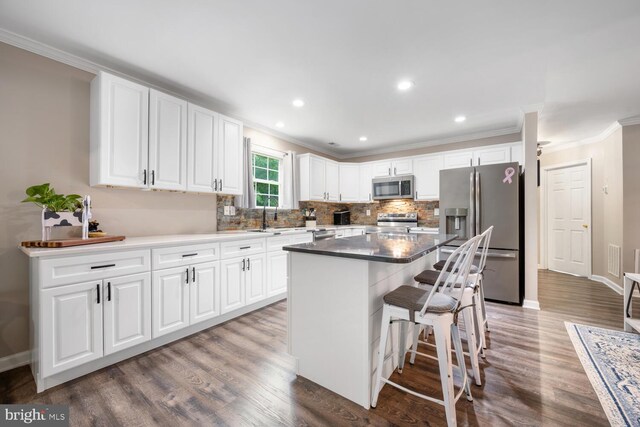 15185 Day Rd, Goldsboro, MD 21636 - kitchen with stainless steel appliances, crown molding, tasteful backsplash, a sink, and a kitchen island