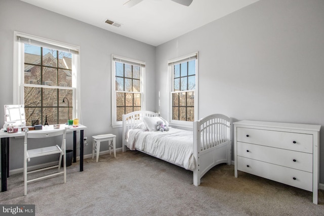 bedroom featuring multiple windows, carpet flooring, and visible vents