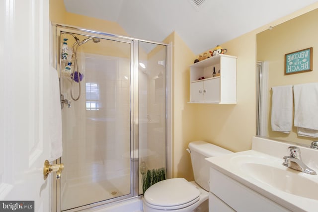 full bathroom with a shower stall, vanity, and toilet