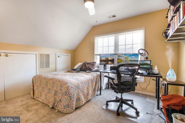 bedroom featuring visible vents, lofted ceiling, carpet, and a ceiling fan