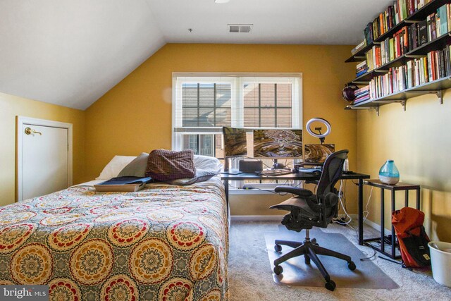 bedroom with visible vents, lofted ceiling, and carpet floors