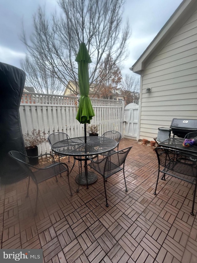 view of patio with outdoor dining space and fence