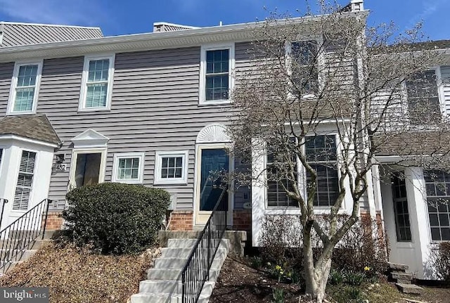 townhome / multi-family property featuring entry steps and brick siding