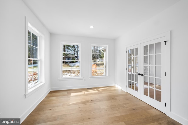 unfurnished sunroom featuring french doors