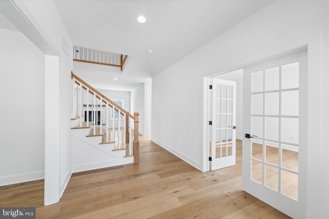 entrance foyer featuring recessed lighting, stairway, baseboards, and wood finished floors