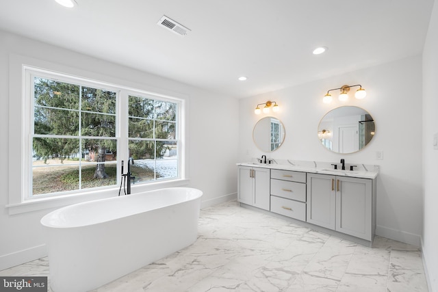 bathroom featuring recessed lighting, marble finish floor, visible vents, and a sink