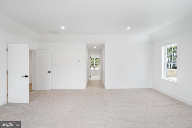 unfurnished bedroom with lofted ceiling, recessed lighting, baseboards, and light colored carpet