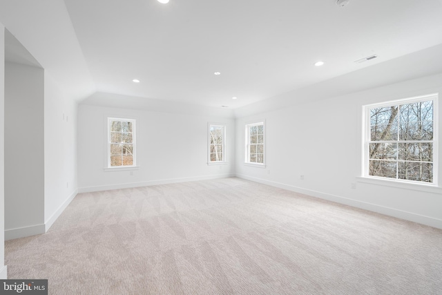 spare room featuring light colored carpet, visible vents, baseboards, and recessed lighting