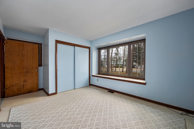 unfurnished bedroom featuring a closet, visible vents, and baseboards