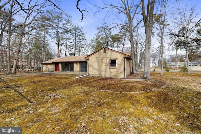 exterior space with an attached carport and brick siding