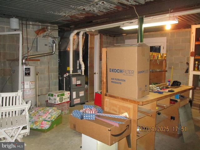 unfinished below grade area featuring heating unit, electric panel, and gas water heater