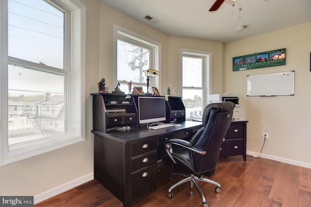 office area with dark wood-style floors, visible vents, and baseboards