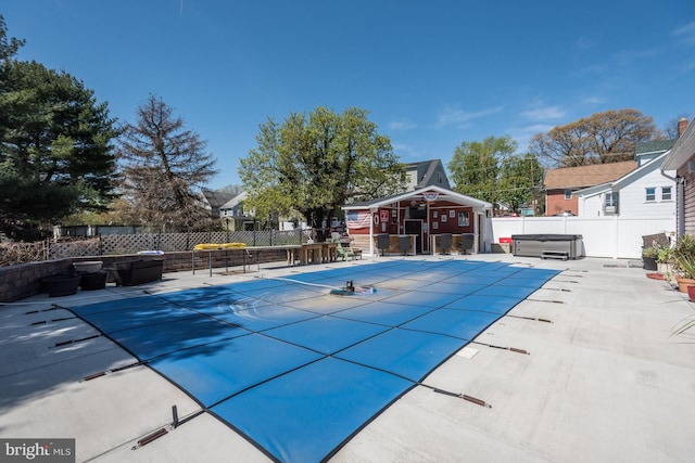 view of pool with a fenced in pool, a patio, a hot tub, fence, and an outdoor structure