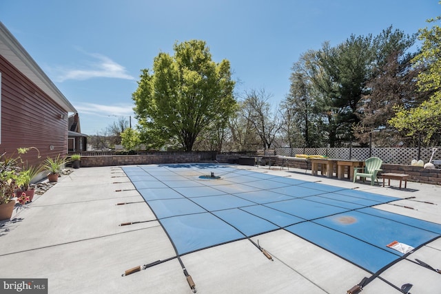 view of swimming pool with a fenced in pool, fence, and a patio