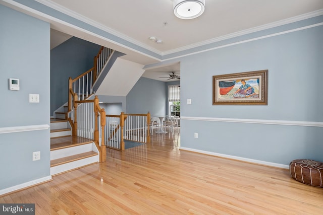 interior space with stairway, a ceiling fan, baseboards, and wood finished floors