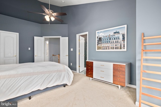 bedroom with light carpet, high vaulted ceiling, and baseboards