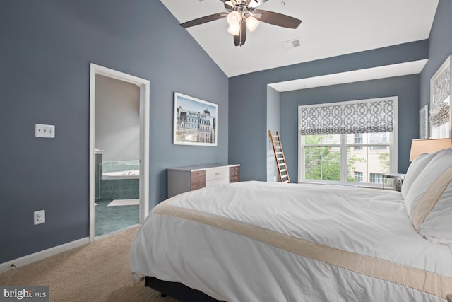 carpeted bedroom featuring lofted ceiling, visible vents, ensuite bathroom, ceiling fan, and baseboards