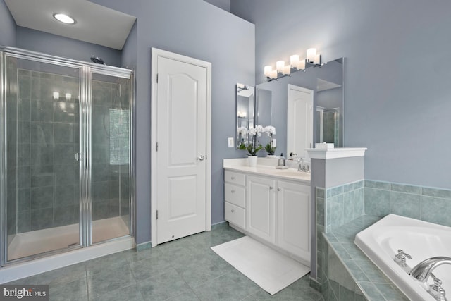 full bath featuring a shower stall, vanity, a bath, and tile patterned floors