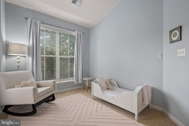 bedroom with carpet, visible vents, vaulted ceiling, and baseboards