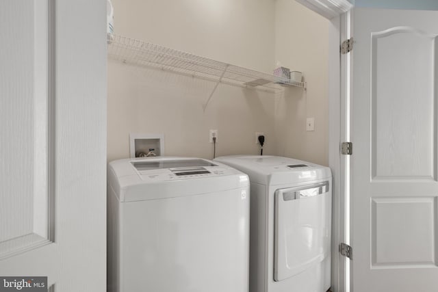 washroom featuring laundry area and washer and clothes dryer