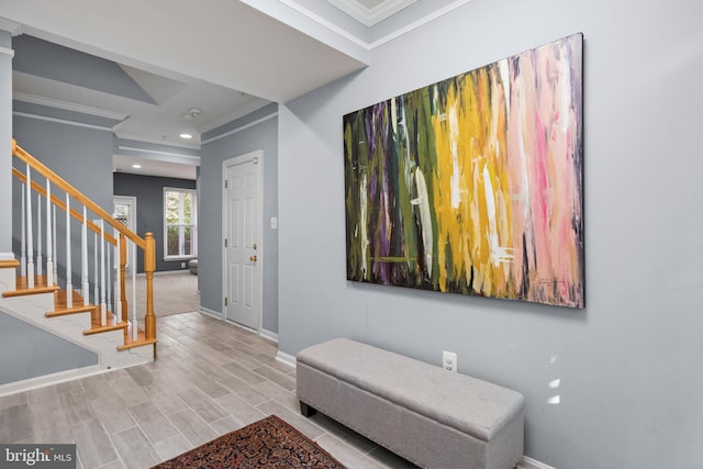 foyer entrance with baseboards, ornamental molding, stairs, wood finish floors, and recessed lighting