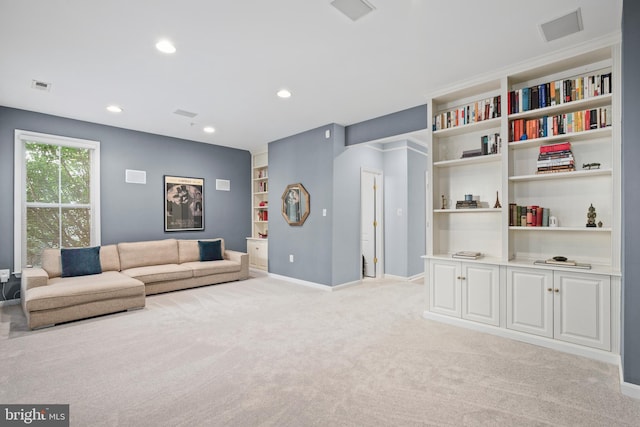 living area with recessed lighting, light colored carpet, visible vents, and baseboards