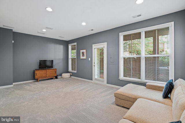 carpeted living area with plenty of natural light, visible vents, baseboards, and recessed lighting