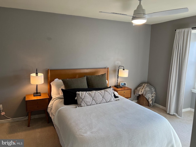 bedroom with light colored carpet, ceiling fan, and baseboards